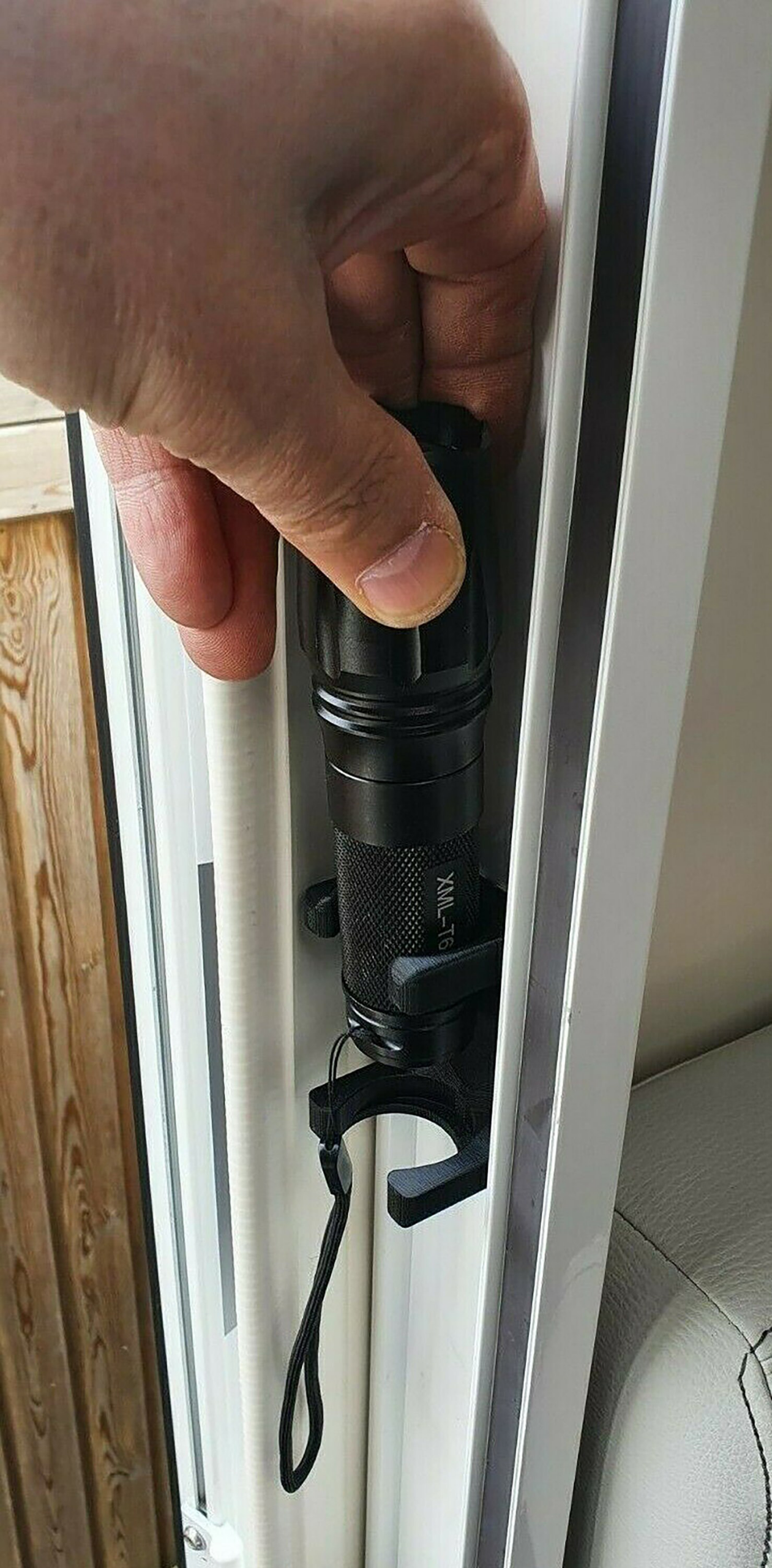 Black wall torch fitted in bracket